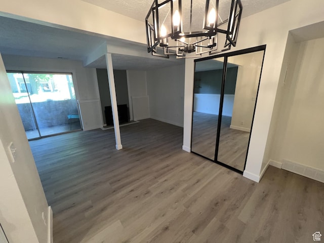 17 E 400 N Unit 27C, Bountiful, UT 84010 - unfurnished dining area featuring wood finished floors, baseboards, a chandelier, and a textured ceiling