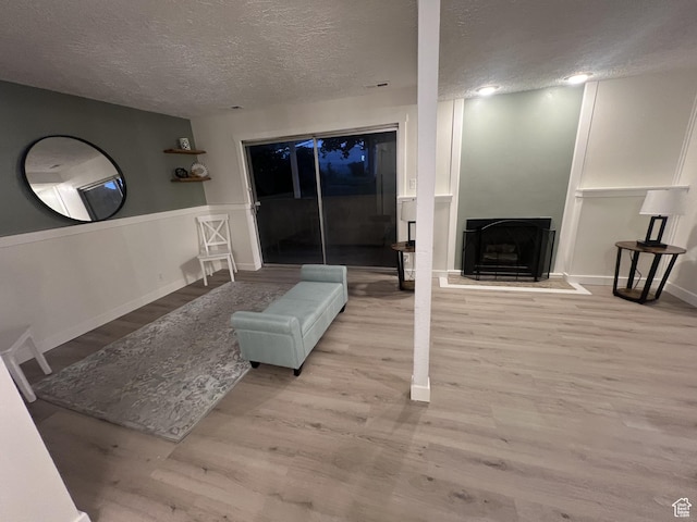 17 E 400 N Unit 27C, Bountiful, UT 84010 - living area featuring a textured ceiling, wood finished floors, and a fireplace