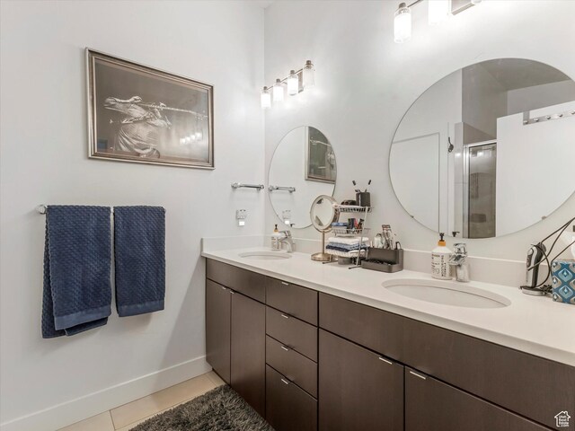 7701 S Navarro View Ct, Midvale, UT 84047 - full bathroom featuring double vanity, tile patterned flooring, a stall shower, and baseboards