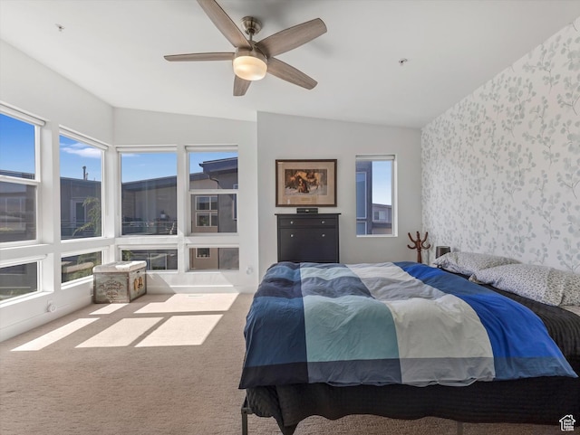 7701 S Navarro View Ct, Midvale, UT 84047 - bedroom with wallpapered walls, carpet floors, vaulted ceiling, multiple windows, and ceiling fan