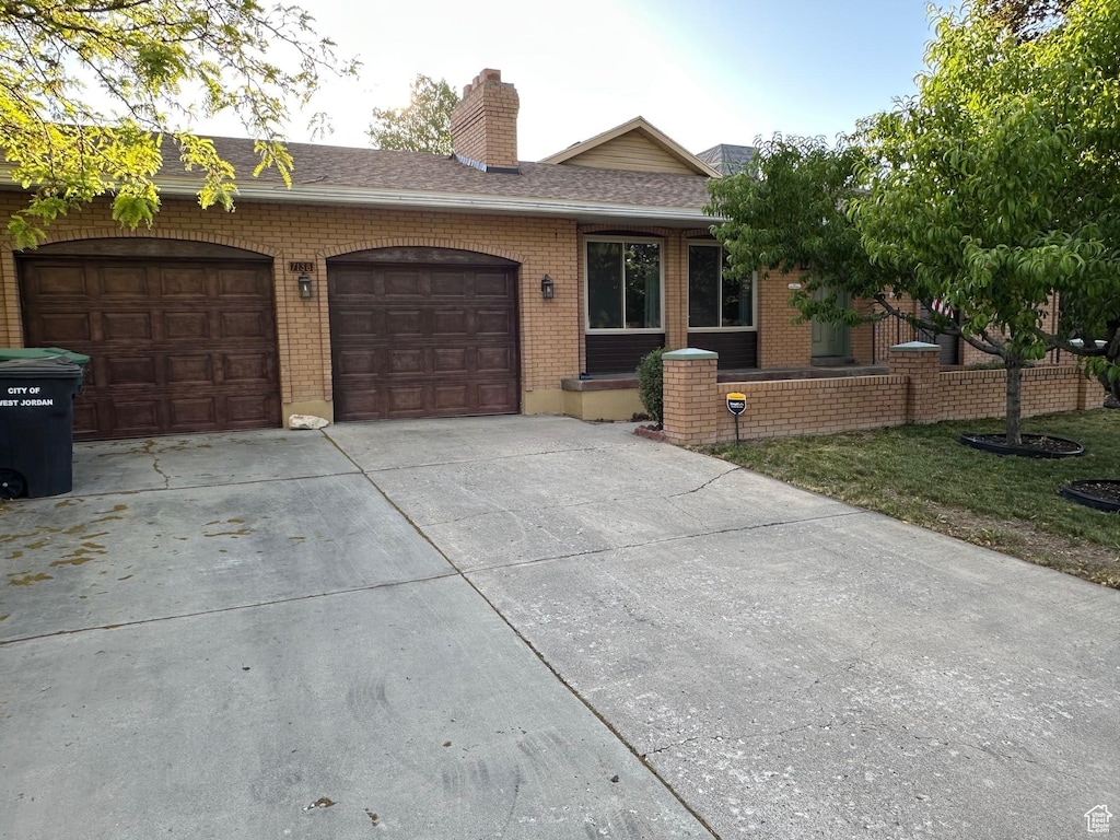 7138 S 2420 W, West Jordan, UT 84084 - single story home with concrete driveway, brick siding, a garage, roof with shingles, and a chimney