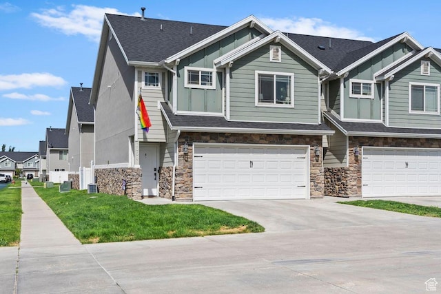 1064 W 2050 S, Syracuse, UT 84075 - multi unit property featuring stone siding, board and batten siding, an attached garage, driveway, and a front lawn