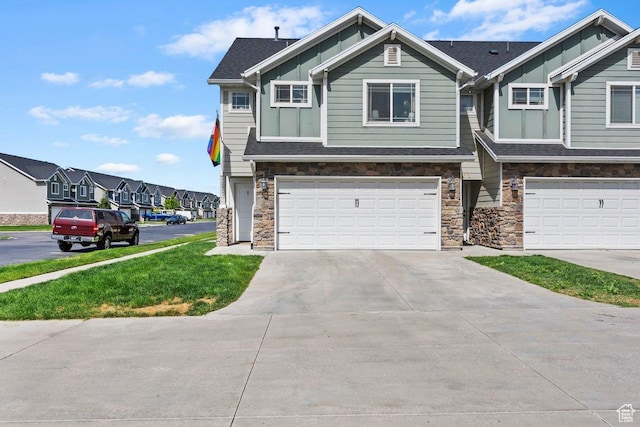 1064 W 2050 S, Syracuse, UT 84075 - craftsman house featuring stone siding, board and batten siding, an attached garage, driveway, and a residential view