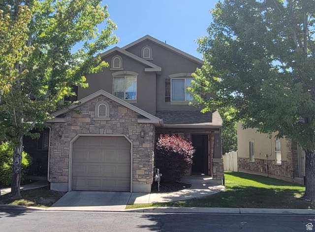581 S 910 W Unit 86, Pleasant Grove, UT 84062 - view of front of property with stucco siding, a garage, stone siding, and concrete driveway