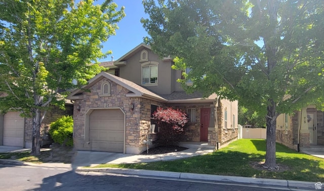 581 S 910 W Unit 86, Pleasant Grove, UT 84062 - view of front facade with stucco siding, stone siding, a garage, and concrete driveway