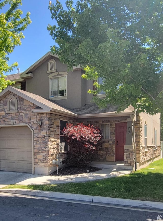 581 S 910 W Unit 86, Pleasant Grove, UT 84062 - view of front facade featuring stone siding, stucco siding, and an attached garage