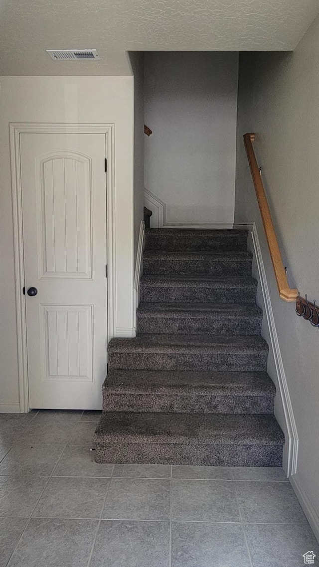 581 S 910 W Unit 86, Pleasant Grove, UT 84062 - stairway with baseboards, tile patterned floors, and a textured ceiling