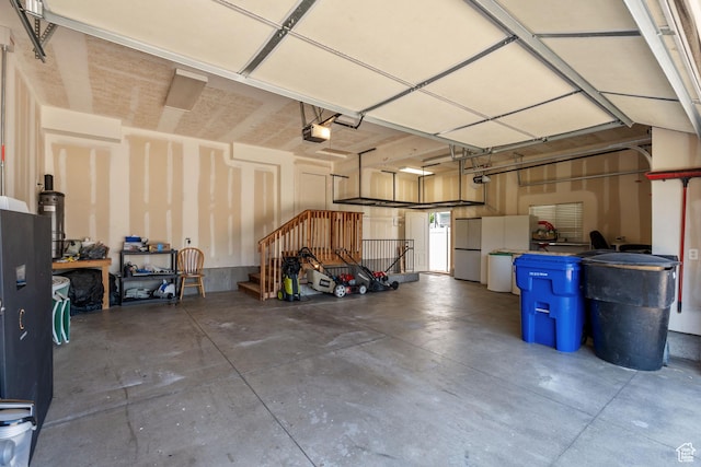 2167 W 2200 S, Syracuse, UT 84075 - garage featuring a garage door opener and fridge