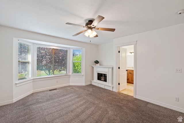 2167 W 2200 S, Syracuse, UT 84075 - unfurnished living room with carpet floors, a ceiling fan, a glass covered fireplace, and baseboards