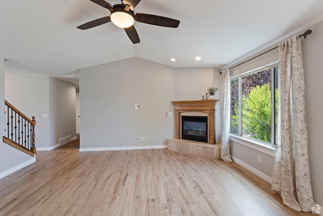 2167 W 2200 S, Syracuse, UT 84075 - unfurnished living room featuring a glass covered fireplace, wood finished floors, stairs, baseboards, and recessed lighting