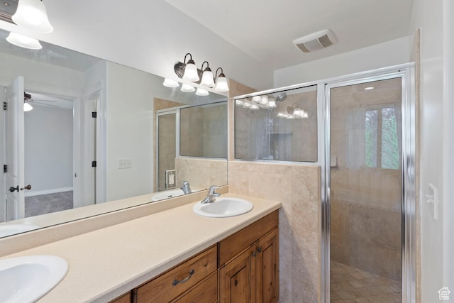 2167 W 2200 S, Syracuse, UT 84075 - bathroom featuring double vanity, a shower stall, a ceiling fan, and tile walls