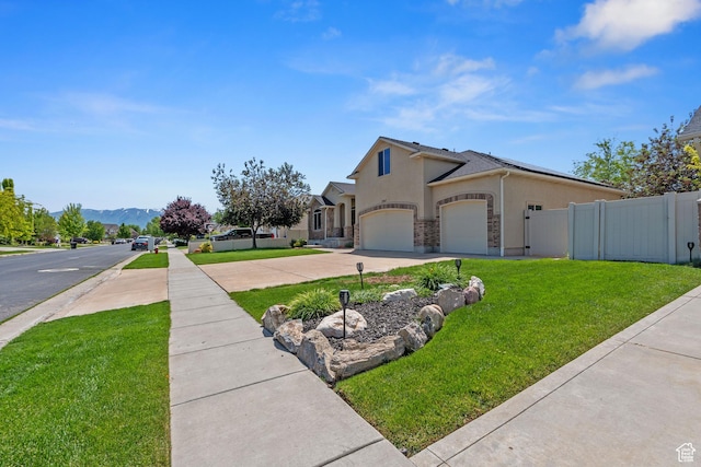2167 W 2200 S, Syracuse, UT 84075 - view of home's exterior featuring stucco siding, driveway, a mountain view, and a garage
