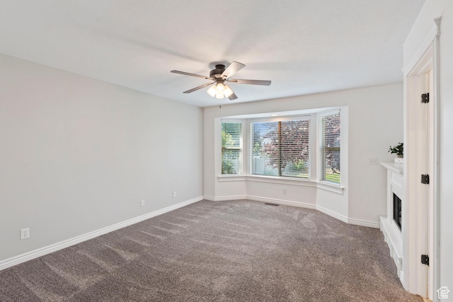 2167 W 2200 S, Syracuse, UT 84075 - carpeted spare room featuring a ceiling fan, baseboards, and a fireplace