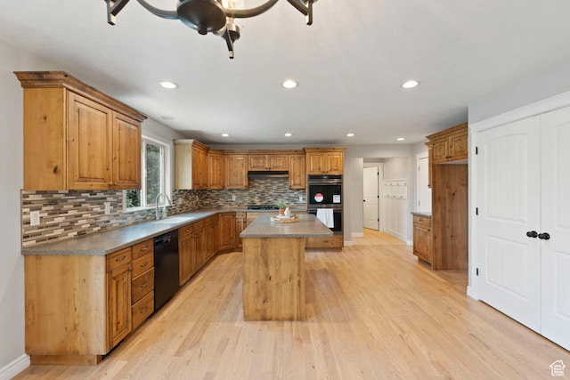 2167 W 2200 S, Syracuse, UT 84075 - kitchen with black dishwasher, double oven, a sink, a center island, and brown cabinetry