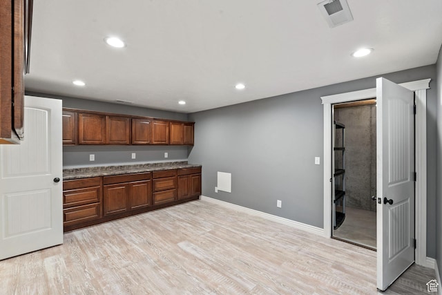 2167 W 2200 S, Syracuse, UT 84075 - kitchen featuring light wood-type flooring, recessed lighting, baseboards, and brown cabinets