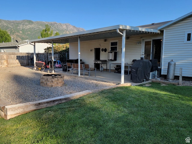 264 W 550 N, Santaquin, UT 84655 - rear view of house featuring a fire pit, a mountain view, and a patio area
