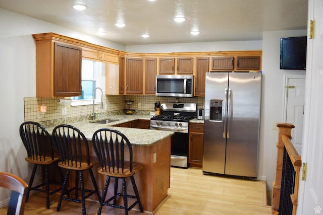 264 W 550 N, Santaquin, UT 84655 - kitchen with stainless steel appliances, a sink, a peninsula, light stone counters, and tasteful backsplash