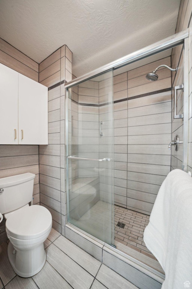 2082 W Jordan Villa Dr, West Jordan, UT 84088 - bathroom featuring a stall shower, toilet, and tile patterned flooring
