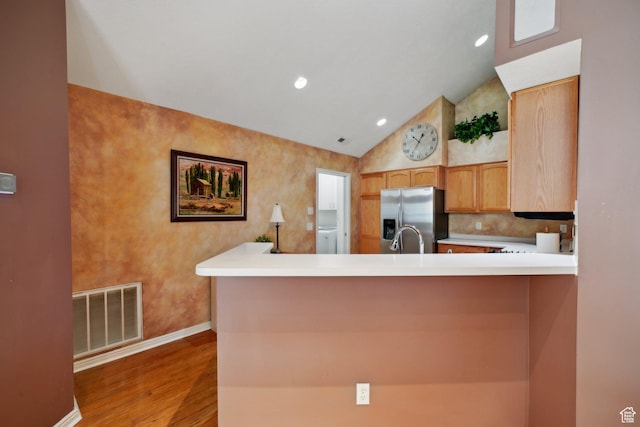 2082 W Jordan Villa Dr, West Jordan, UT 84088 - kitchen with stainless steel fridge, wood finished floors, lofted ceiling, baseboards, and a peninsula