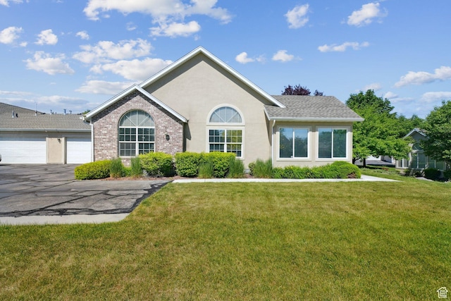 2082 W Jordan Villa Dr, West Jordan, UT 84088 - ranch-style house featuring an attached garage, asphalt driveway, a front lawn, and stucco siding
