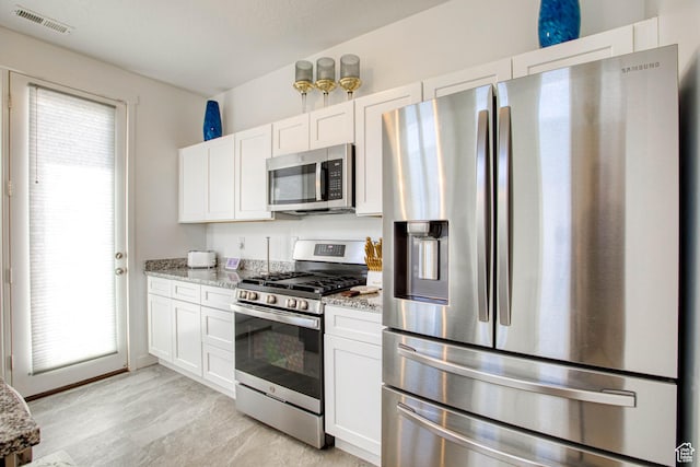 7776 S Iron Core Ln, West Jordan, UT 84081 - kitchen featuring stainless steel appliances, light stone countertops, and white cabinets