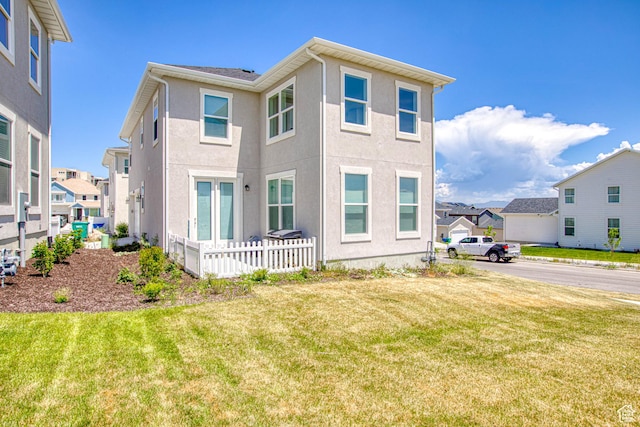 7776 S Iron Core Ln, West Jordan, UT 84081 - view of front of home with a residential view, stucco siding, and a front yard
