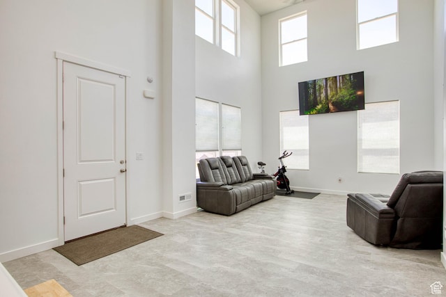 7776 S Iron Core Ln, West Jordan, UT 84081 - living area featuring a high ceiling and baseboards