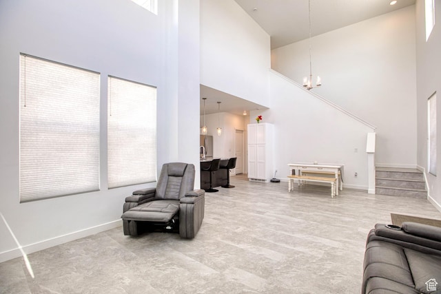7776 S Iron Core Ln, West Jordan, UT 84081 - living area featuring a towering ceiling, a chandelier, and baseboards