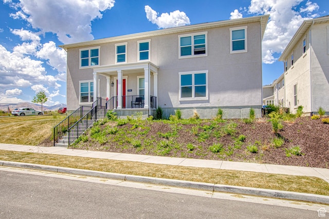7776 S Iron Core Ln, West Jordan, UT 84081 - view of front facade with a porch and stucco siding