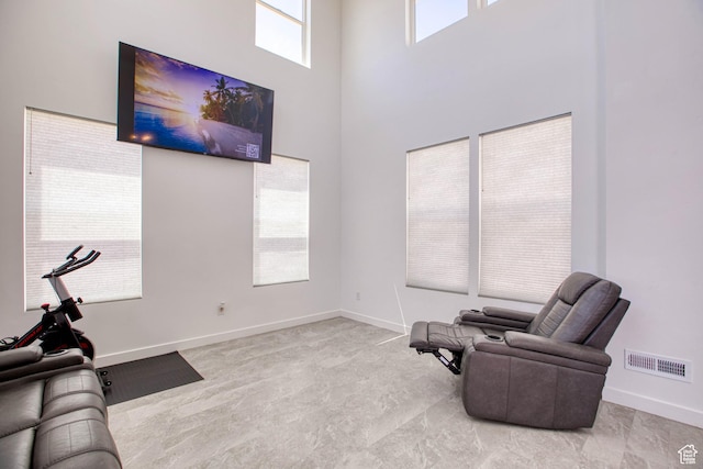 7776 S Iron Core Ln, West Jordan, UT 84081 - living area featuring a high ceiling and baseboards