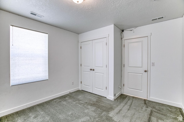 7776 S Iron Core Ln, West Jordan, UT 84081 - unfurnished bedroom featuring a textured ceiling, carpet flooring, a closet, and baseboards