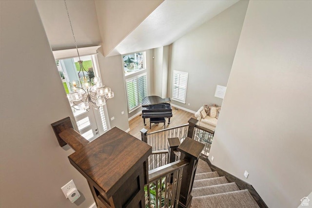 8176 S Chilwell Cv W, West Jordan, UT 84081 - stairs with high vaulted ceiling, baseboards, a chandelier, and wood finished floors