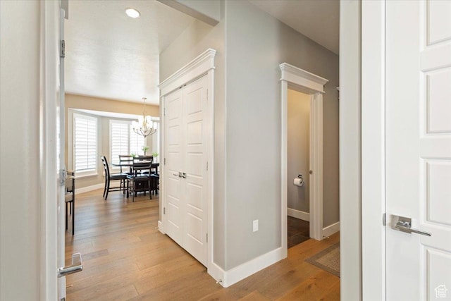 8176 S Chilwell Cv W, West Jordan, UT 84081 - hall featuring a chandelier, light wood-style floors, and baseboards