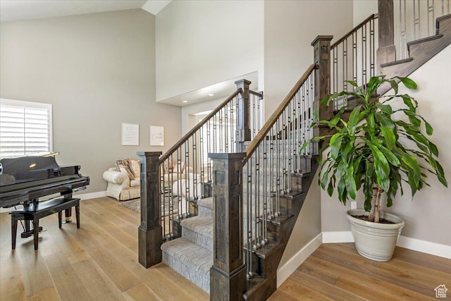 8176 S Chilwell Cv W, West Jordan, UT 84081 - stairs with high vaulted ceiling, baseboards, and wood finished floors