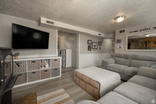 392 N 600 E, Roosevelt, UT 84066 - living room with a textured ceiling, wood finished floors, and a wood stove