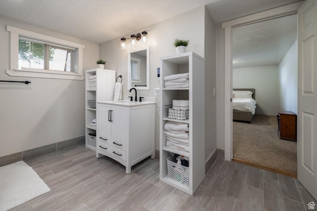 392 N 600 E, Roosevelt, UT 84066 - full bathroom with vanity, wood finished floors, ensuite bath, and baseboards