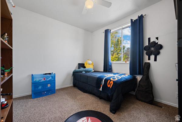 6093 S Longmore Dr, Kearns, UT 84118 - carpeted bedroom featuring ceiling fan and baseboards