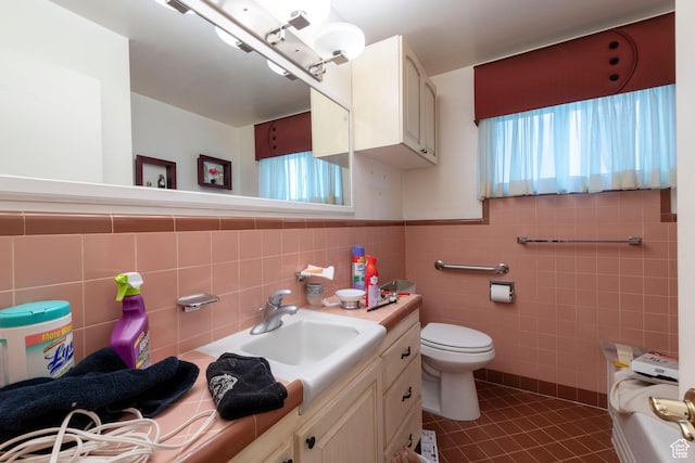 3695 S 2140 E, Salt Lake City, UT 84109 - bathroom with vanity, tile patterned floors, tile walls, toilet, and wainscoting