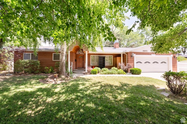 3695 S 2140 E, Salt Lake City, UT 84109 - view of front of home with brick siding, a garage, a front lawn, and a chimney