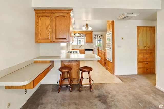 1130 W 1200 N, Provo, UT 84604 - kitchen with white appliances, a sink, a peninsula, light carpet, and light countertops