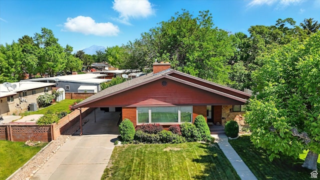 1130 W 1200 N, Provo, UT 84604 - view of front of home with driveway, an attached carport, brick siding, and a front lawn