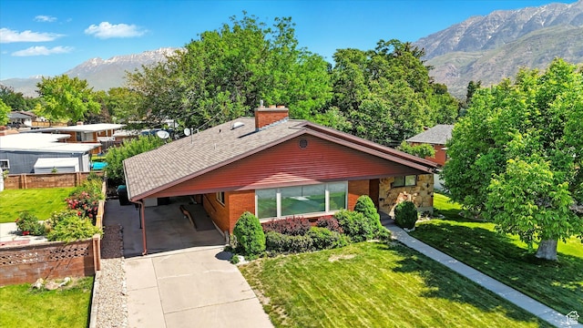 1130 W 1200 N, Provo, UT 84604 - view of front facade featuring a mountain view, concrete driveway, an attached carport, brick siding, and roof with shingles