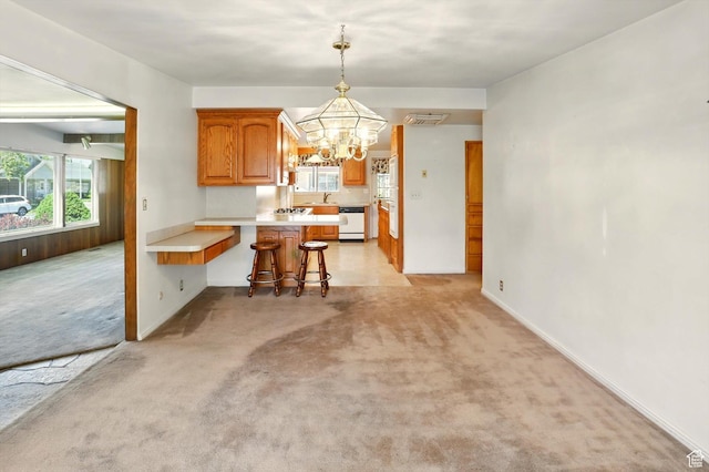 1130 W 1200 N, Provo, UT 84604 - kitchen featuring dishwashing machine, a peninsula, a chandelier, light colored carpet, and light countertops