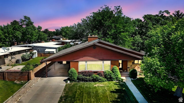 1130 W 1200 N, Provo, UT 84604 - view of front of home featuring brick siding, concrete driveway, a chimney, a front lawn, and a carport