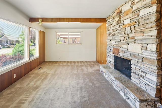 1130 W 1200 N, Provo, UT 84604 - unfurnished living room featuring carpet flooring, wooden walls, a stone fireplace, and beamed ceiling