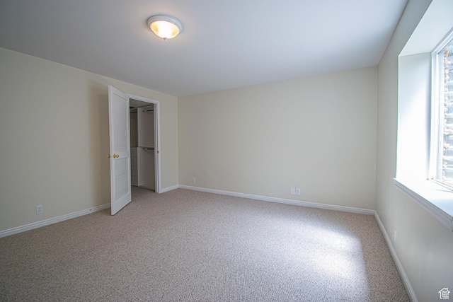 584 S Oak Ln, Tooele, UT 84074 - unfurnished bedroom with multiple windows, baseboards, and light carpet