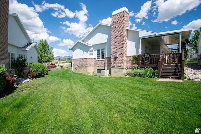 584 S Oak Ln, Tooele, UT 84074 - view of home's exterior featuring a yard, a wooden deck, a chimney, and stucco siding