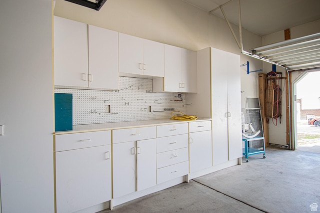 584 S Oak Ln, Tooele, UT 84074 - kitchen with light countertops, white cabinets, tasteful backsplash, and concrete floors