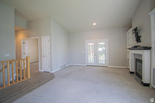 584 S Oak Ln, Tooele, UT 84074 - unfurnished living room featuring carpet flooring, french doors, a fireplace, baseboards, and recessed lighting