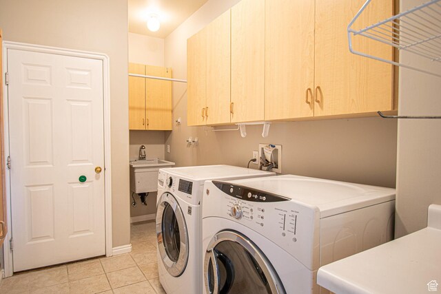 584 S Oak Ln, Tooele, UT 84074 - laundry room with cabinet space, washing machine and dryer, light tile patterned flooring, and baseboards
